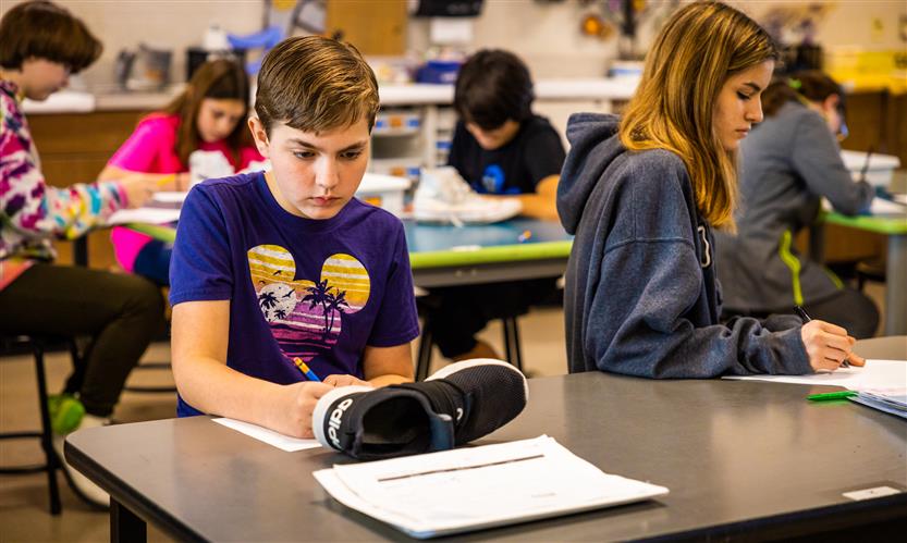 Students sketch shoes during art class